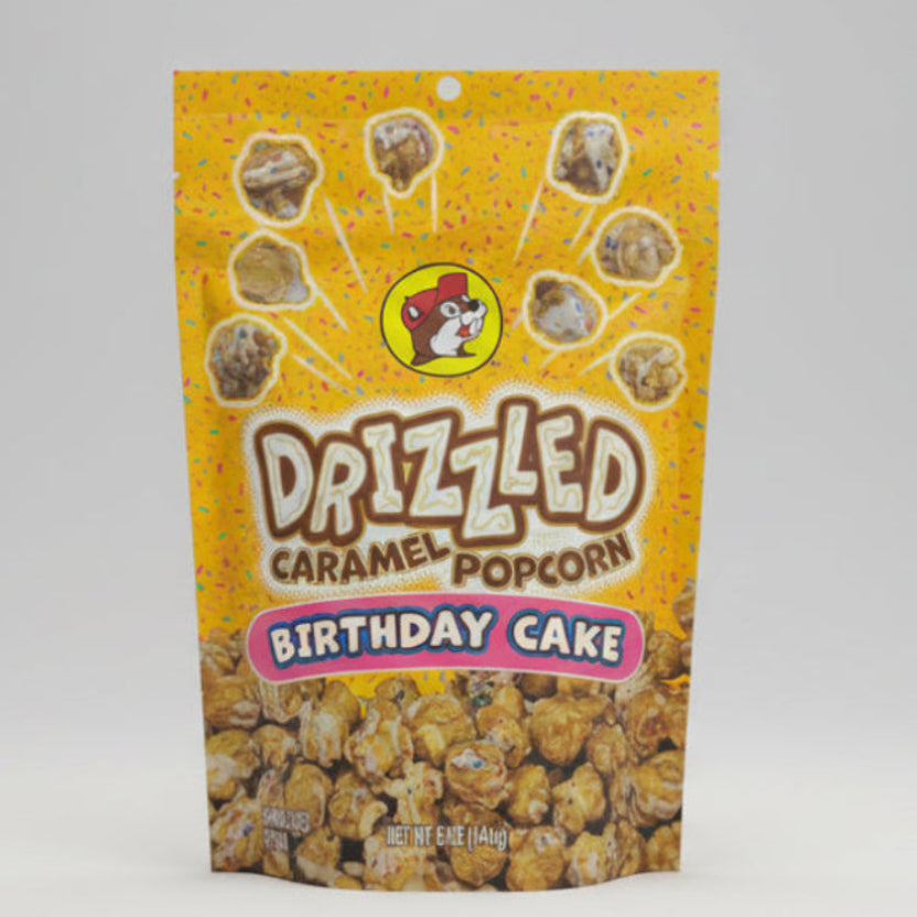 Packaged Dazzled Caramel Popcorn Birthday Cake flavor on a gray background
