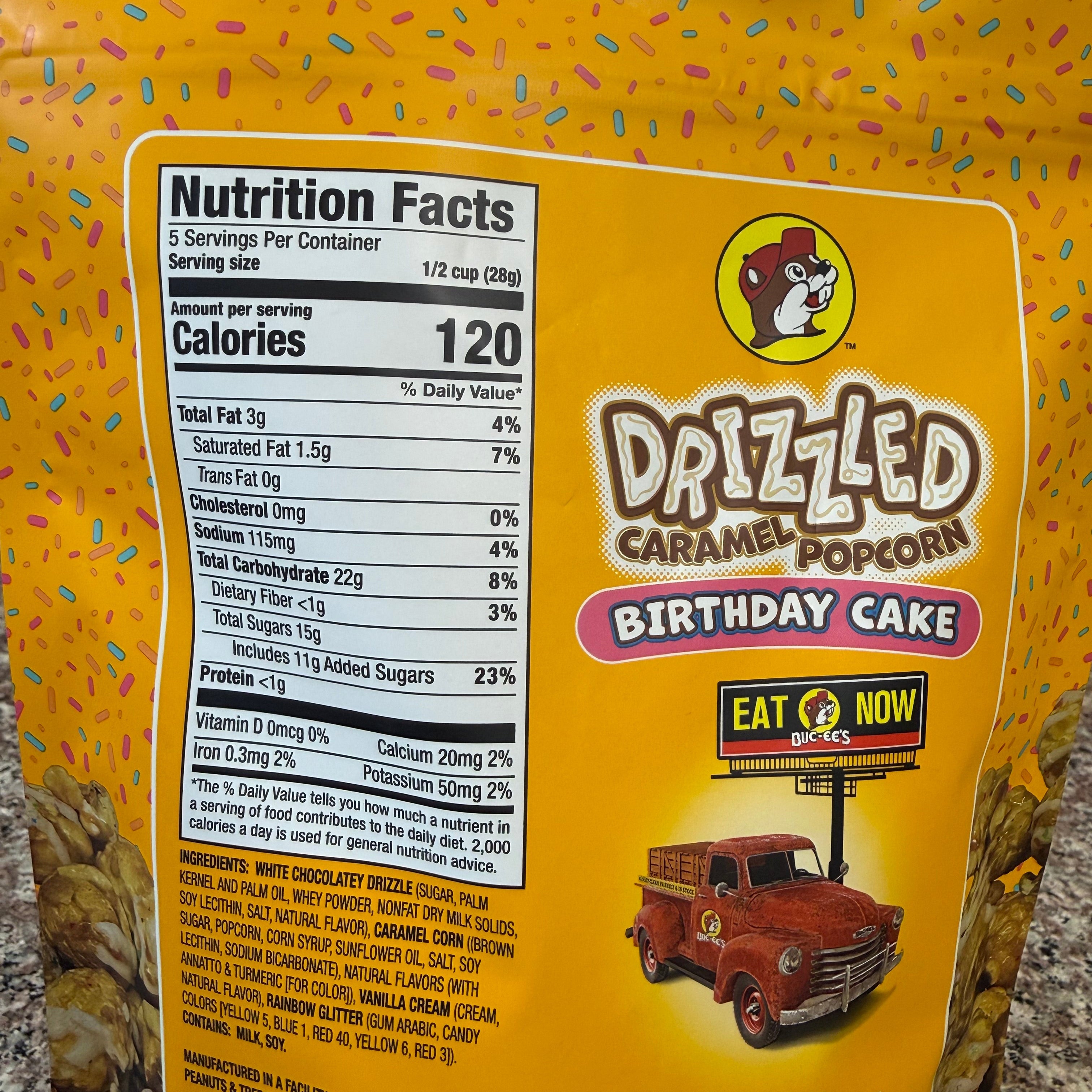 Drizzled Caramel Popcorn Birthday Cake flavor packaging with nutrition facts label.