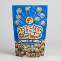 Packaging of Drizzled Caramel Popcorn Cookies N' Cream flavor on a gray background