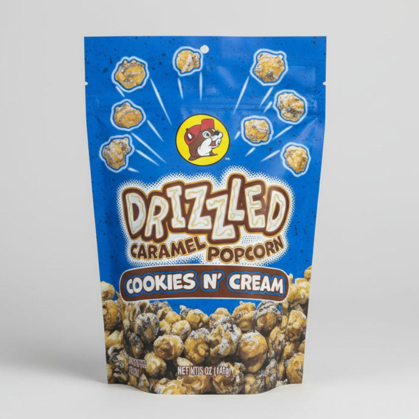 Packaging of Drizzled Caramel Popcorn Cookies N' Cream flavor on a gray background